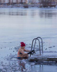 woman doing a cold water immersion in a lake